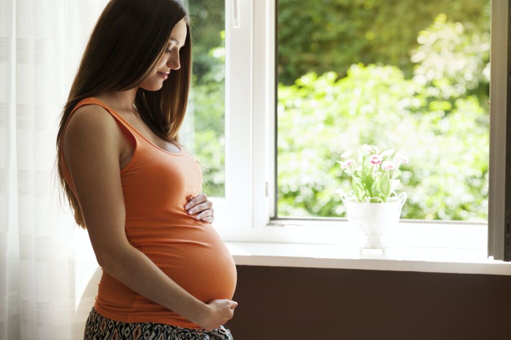 Natural woman in pregnant at home